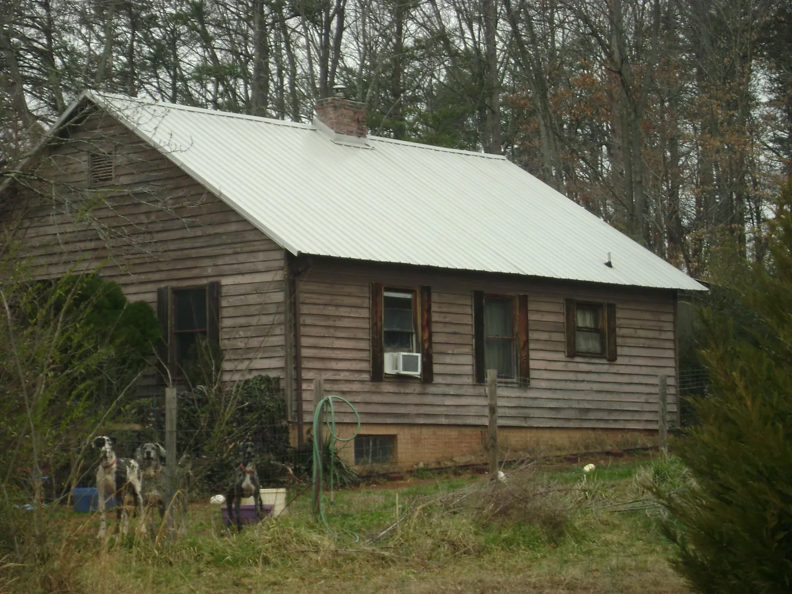White metal roof on an old wood sided farmhouse, from a Metal Roof Installation job in West Orange